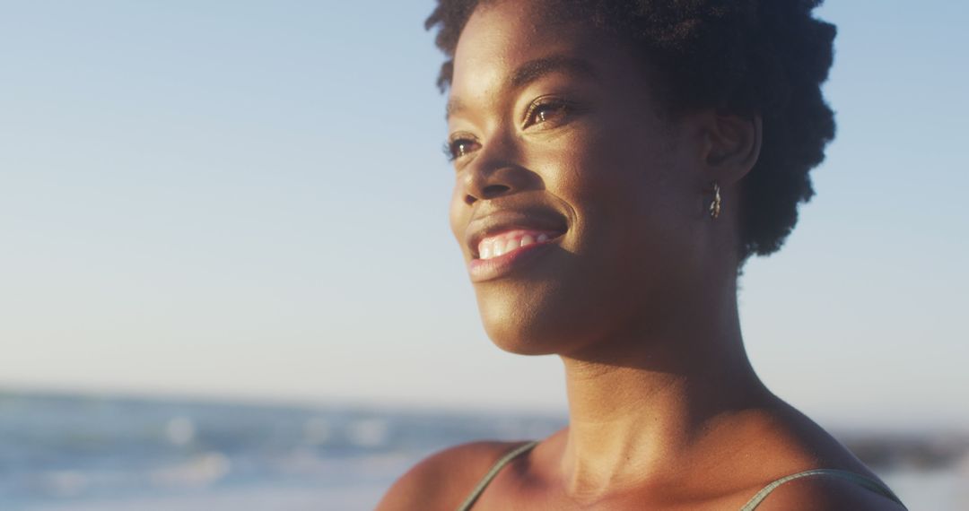 Smiling Woman Enjoying Sunset on Beach - Free Images, Stock Photos and Pictures on Pikwizard.com