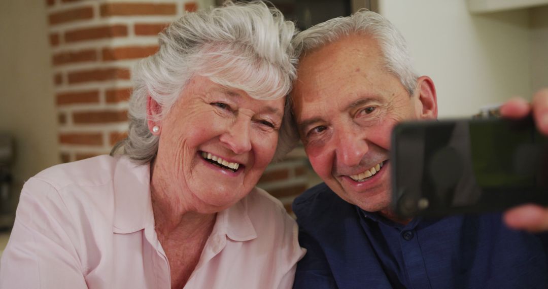 Elderly Couple Taking Selfie Together at Home