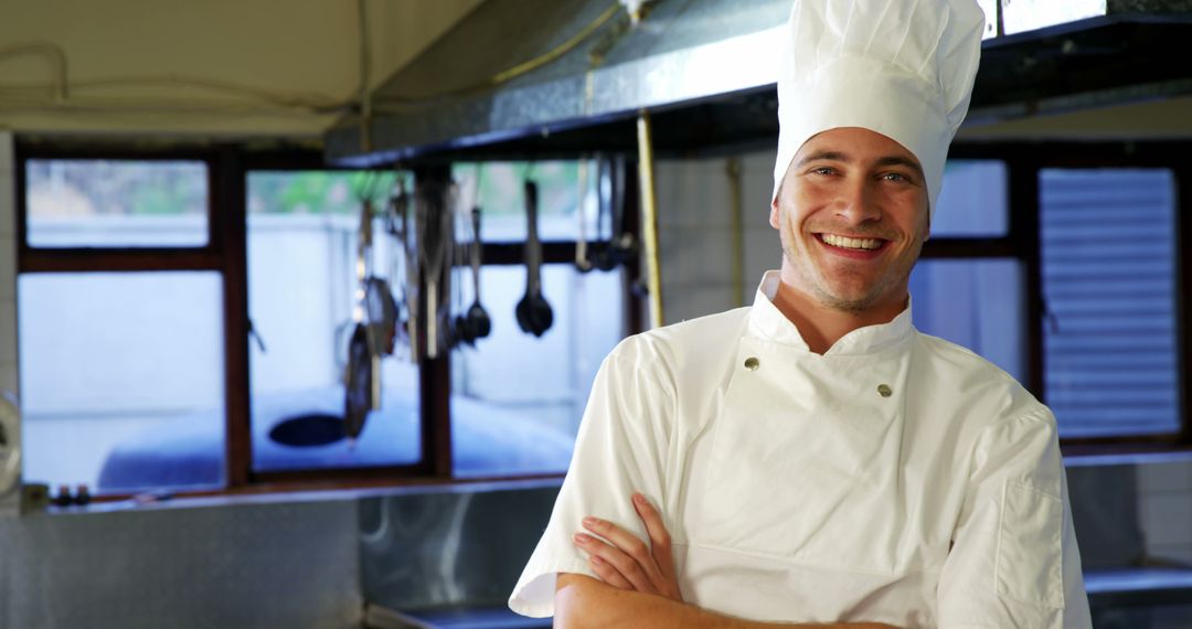 Smiling Chef in Professional Kitchen with Utensils - Free Images, Stock Photos and Pictures on Pikwizard.com