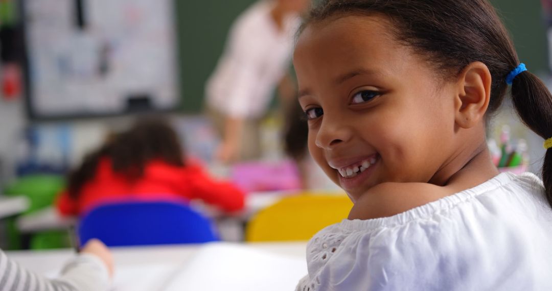 Smiling Schoolgirl Turning Around in Classroom