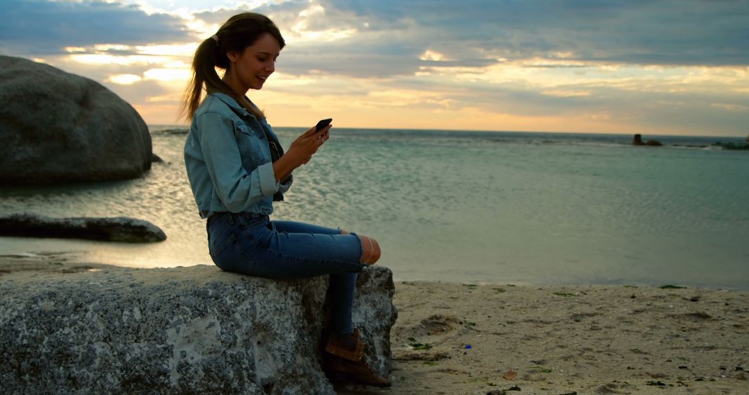 Woman at Beach at Sunset Using Smartphone - Free Images, Stock Photos and Pictures on Pikwizard.com