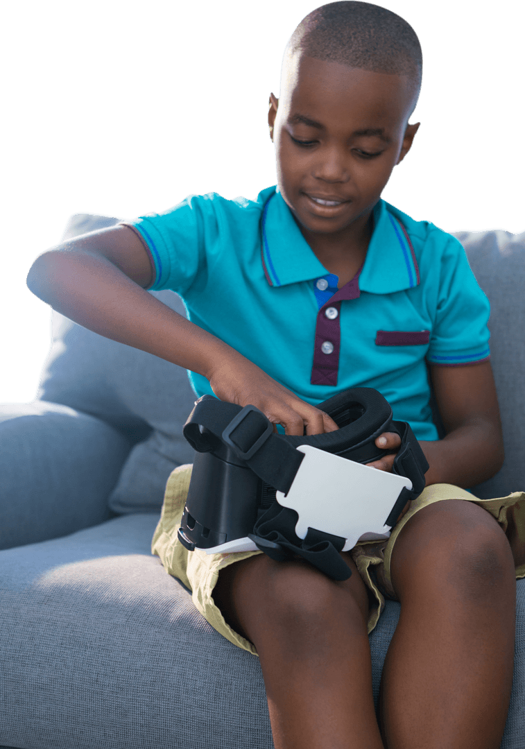 Young Boy Engaging with Virtual Reality Viewer on Couch Transparent
