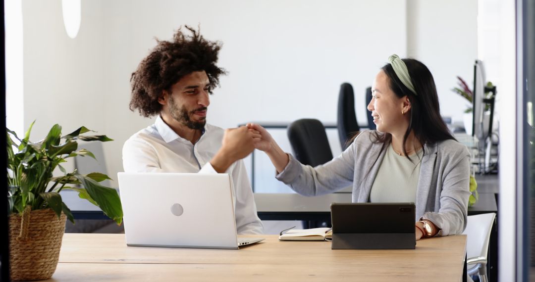 Colleagues Celebrating Success Over Digital Presentation in Office