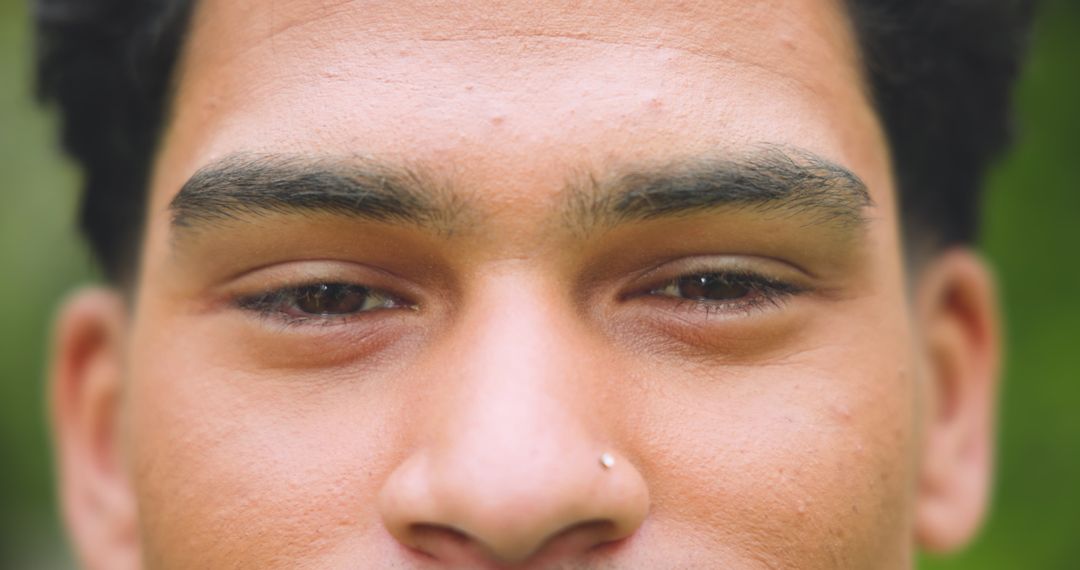 Close-Up Portrait of Man with Nose Stud and Natural Expression