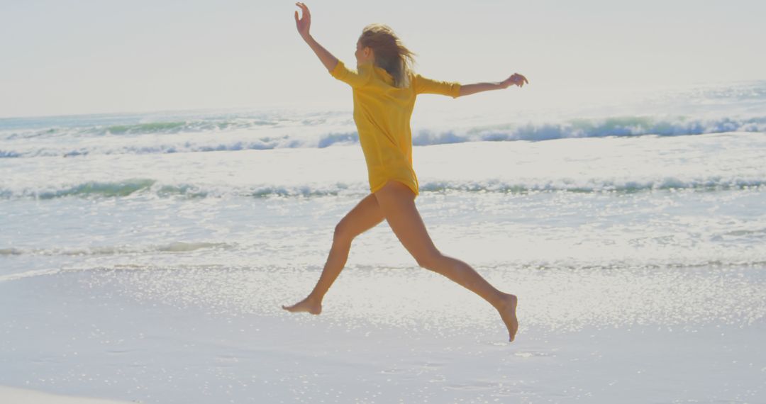 Woman Running and Jumping on Sunny Beach - Free Images, Stock Photos and Pictures on Pikwizard.com