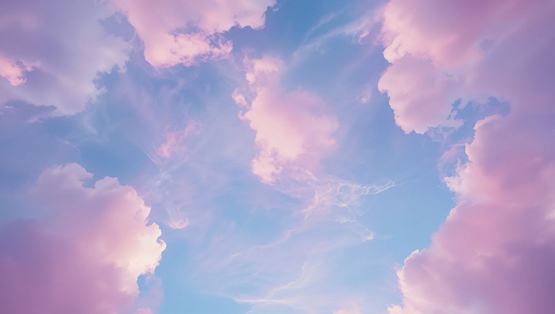 Dreamy Pink Clouds Floating in Clear Blue Sky