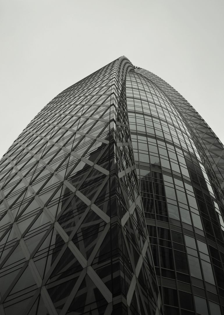 Modern Skyscraper with Glass Facade and Unique Architectural Design - Free Images, Stock Photos and Pictures on Pikwizard.com
