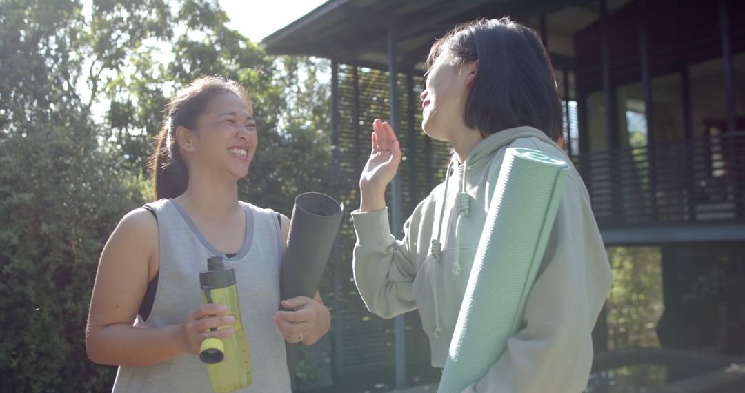 Two Young Women Enjoying Outdoor Exercise with Yoga Mats and Water Bottle - Free Images, Stock Photos and Pictures on Pikwizard.com