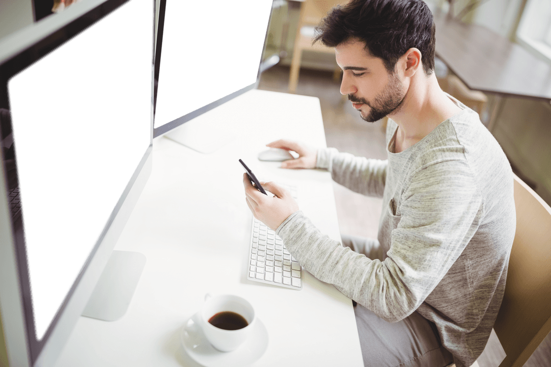 Transparent Monitors in Modern Office Featuring Man Using Cell Phone