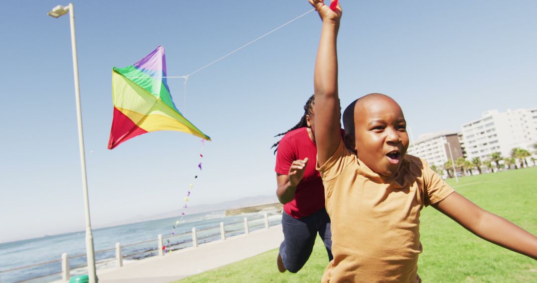 Children Flying Colorful Kite on Sunny Day - Free Images, Stock Photos and Pictures on Pikwizard.com