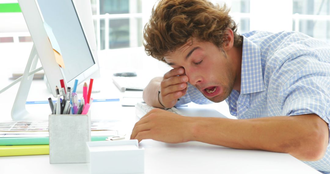 Tired Young Man Falling Asleep at Desk in Office - Free Images, Stock Photos and Pictures on Pikwizard.com