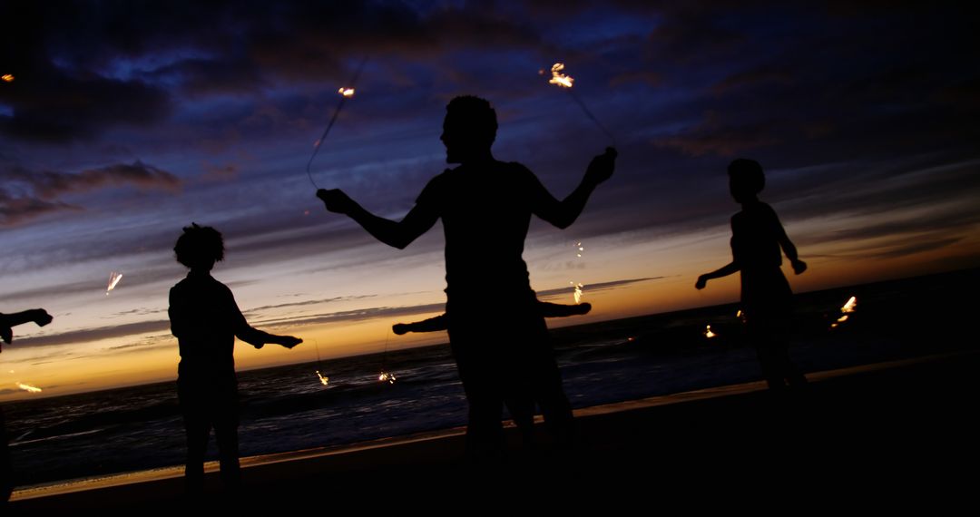 Silhouettes of Fire Performers at Sunset Beach - Free Images, Stock Photos and Pictures on Pikwizard.com