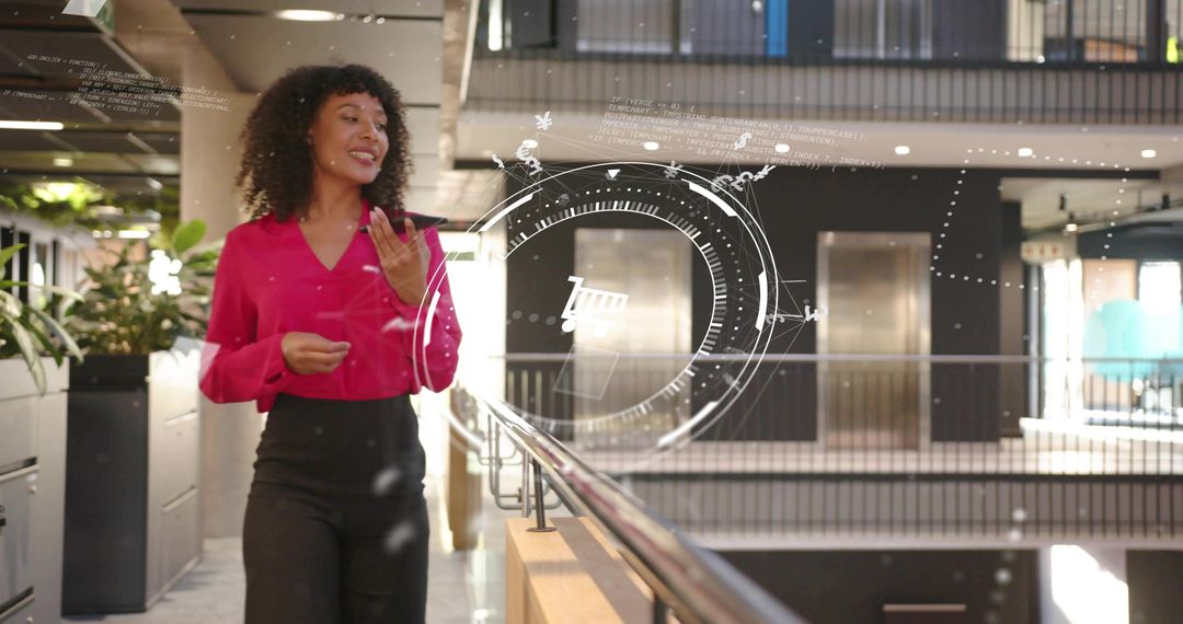 Professional Woman Presenting with Futuristic HUD Graphics in Office Atrium