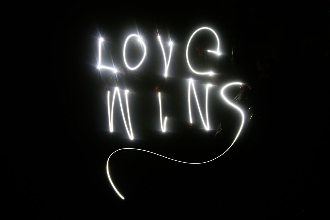 Glowing Light Art with Inspirational Love Wins Message