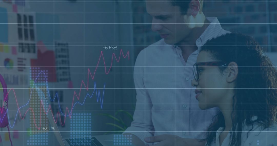 Diverse Professionals Analyzing Digital Financial Graphs in Modern Office