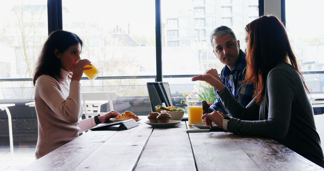 Colleagues Eating and Discussing During Lunch Meeting