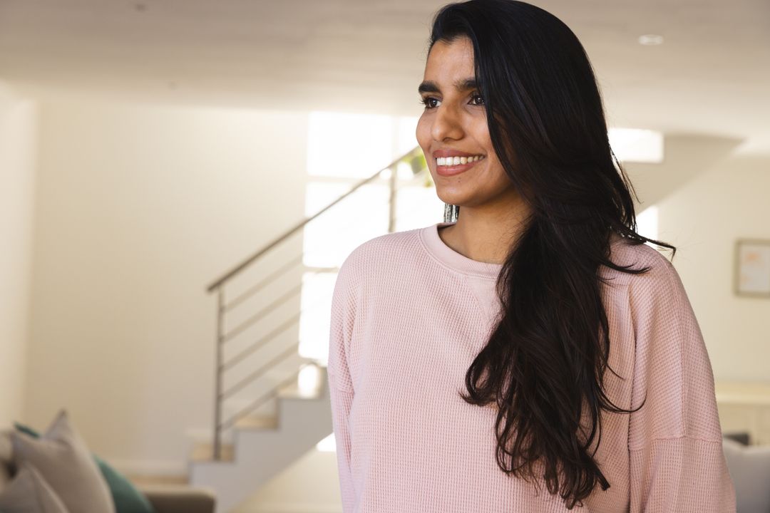 Smiling Woman Standing in Minimalist Living Room with Modern Decor