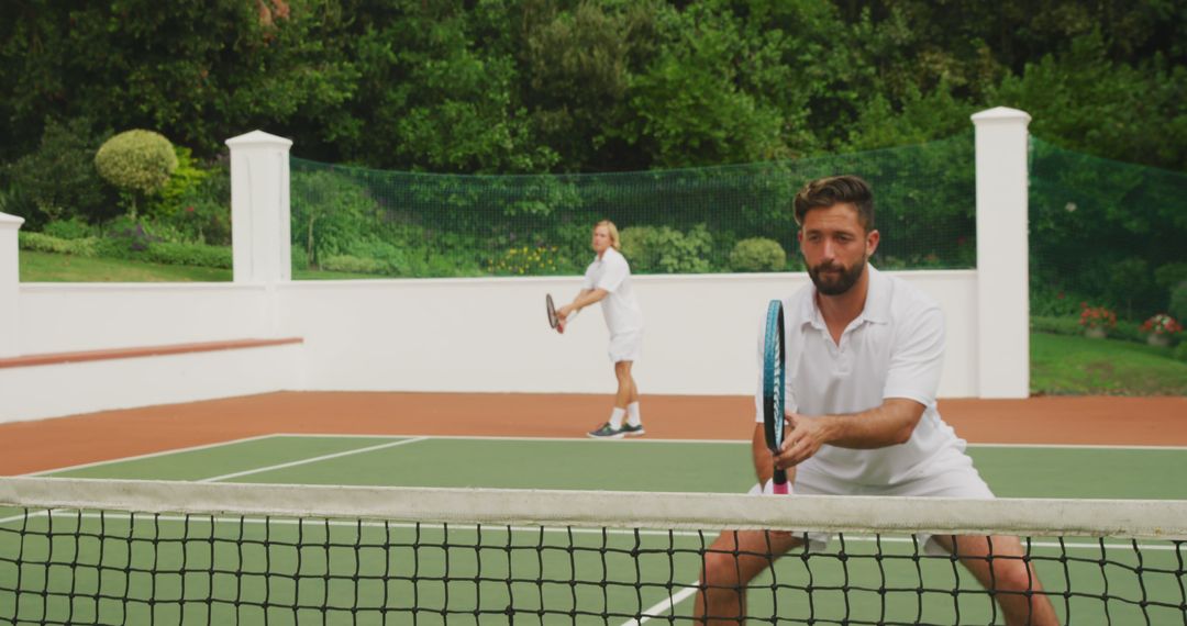 Men Playing Doubles Tennis Match on Outdoor Clay Court - Free Images, Stock Photos and Pictures on Pikwizard.com