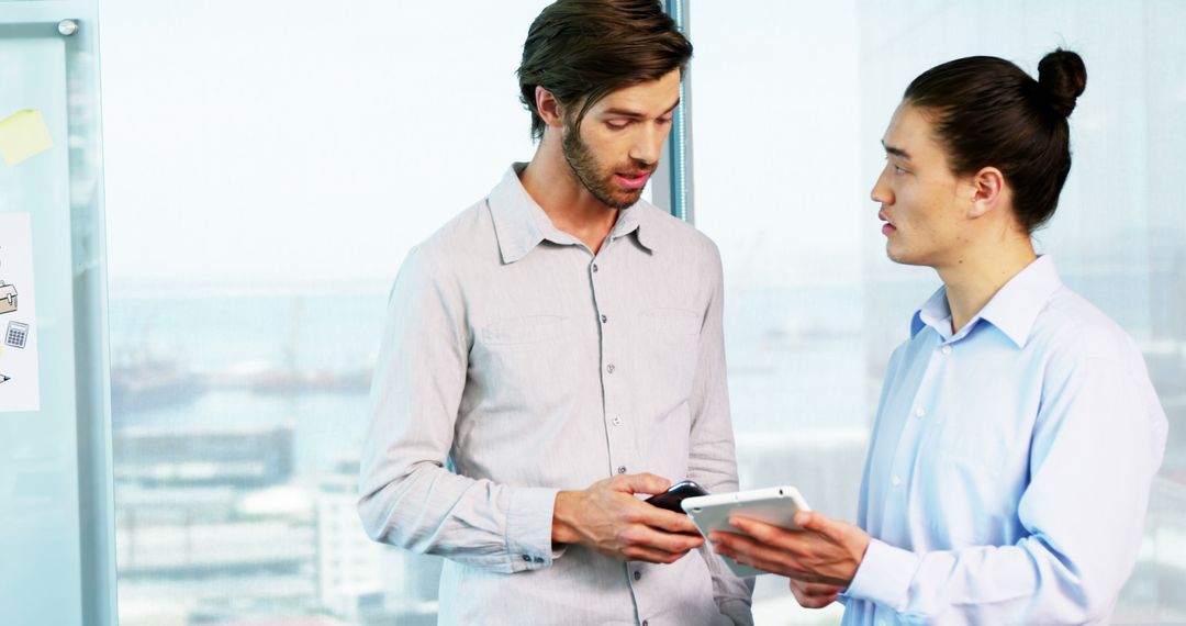 Businessmen Discussing Digital Strategy with Tablet in Modern Office