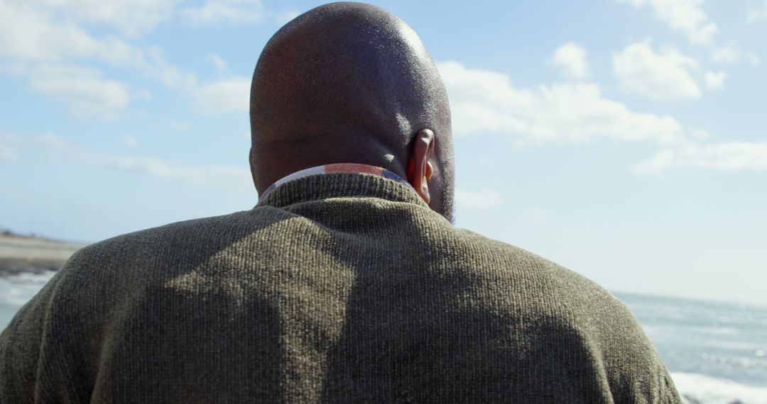 Man Enjoying Serene Ocean View on Sunny Day