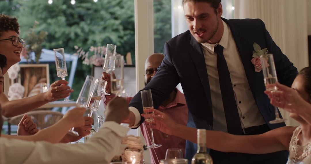 Groom Giving Toast at Wedding Reception with Smiling Friends