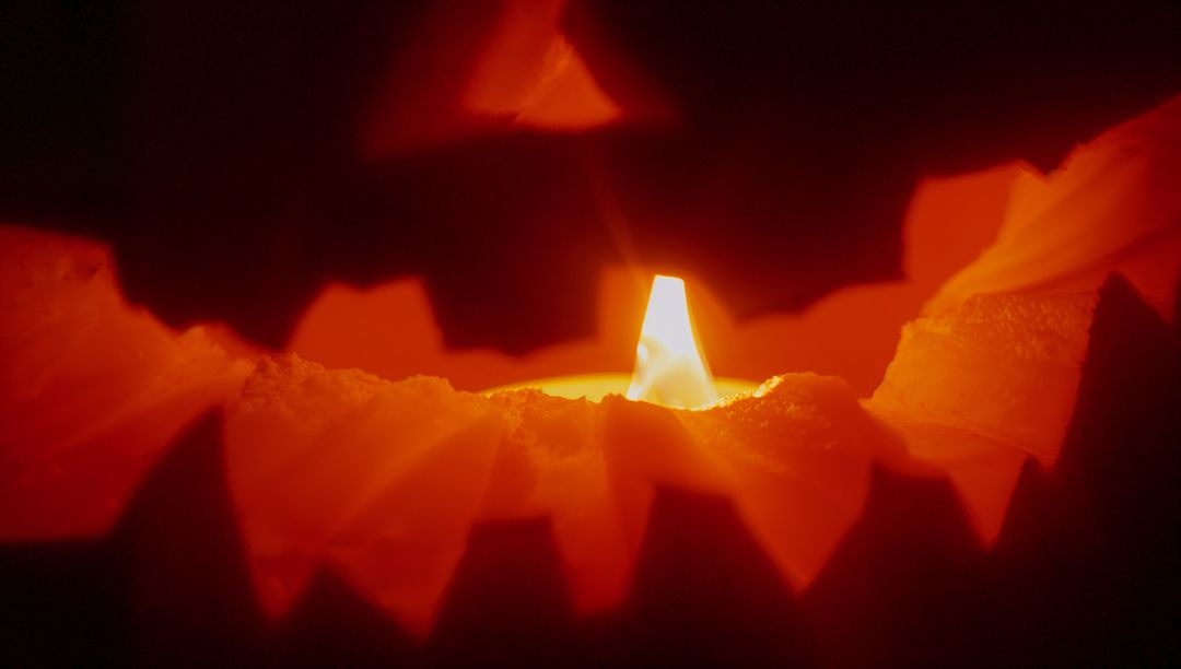 Glowing Jack-O'-Lantern Closeup with Flickering Candle