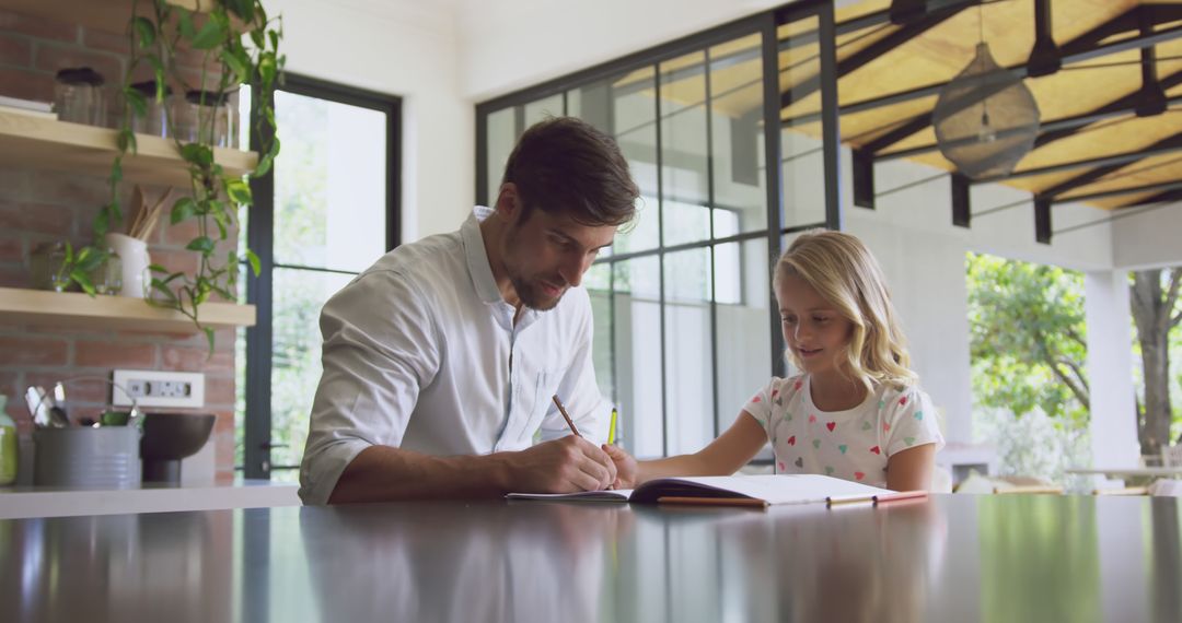 Father Helping Daughter with Homework in Modern Kitchen - Free Images, Stock Photos and Pictures on Pikwizard.com