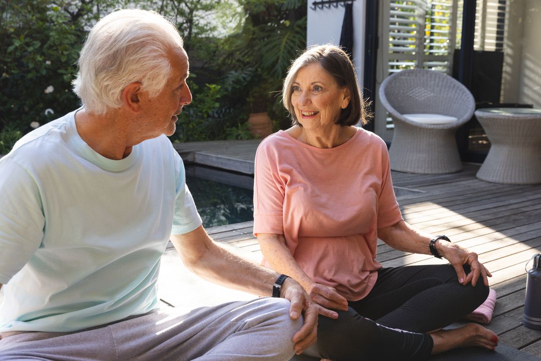 Senior Couple Enjoying Relaxation by Backyard Pool