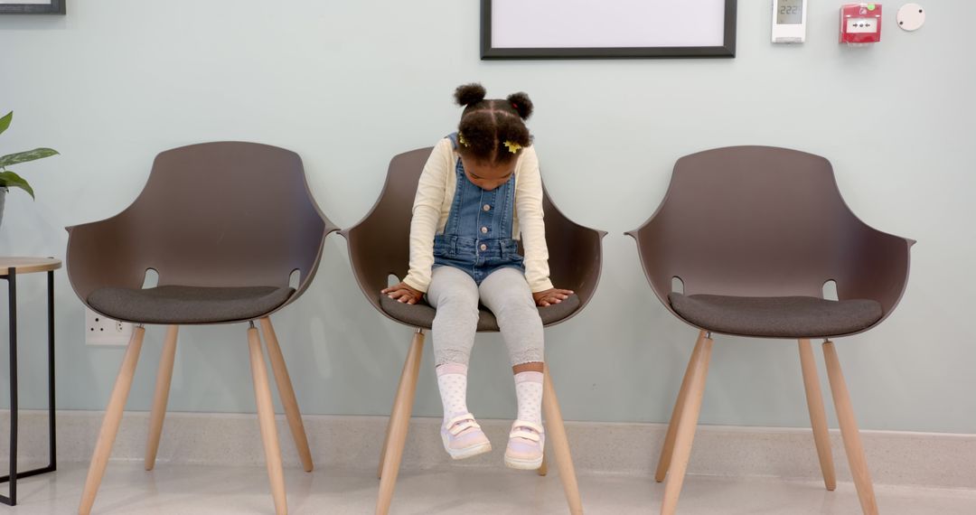 Little Girl Sitting on Waiting Room Chair with Head Down - Free Images, Stock Photos and Pictures on Pikwizard.com