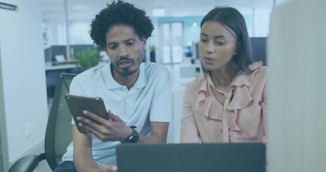 Team Collaborating at Modern Open-Plan Office with Technology
