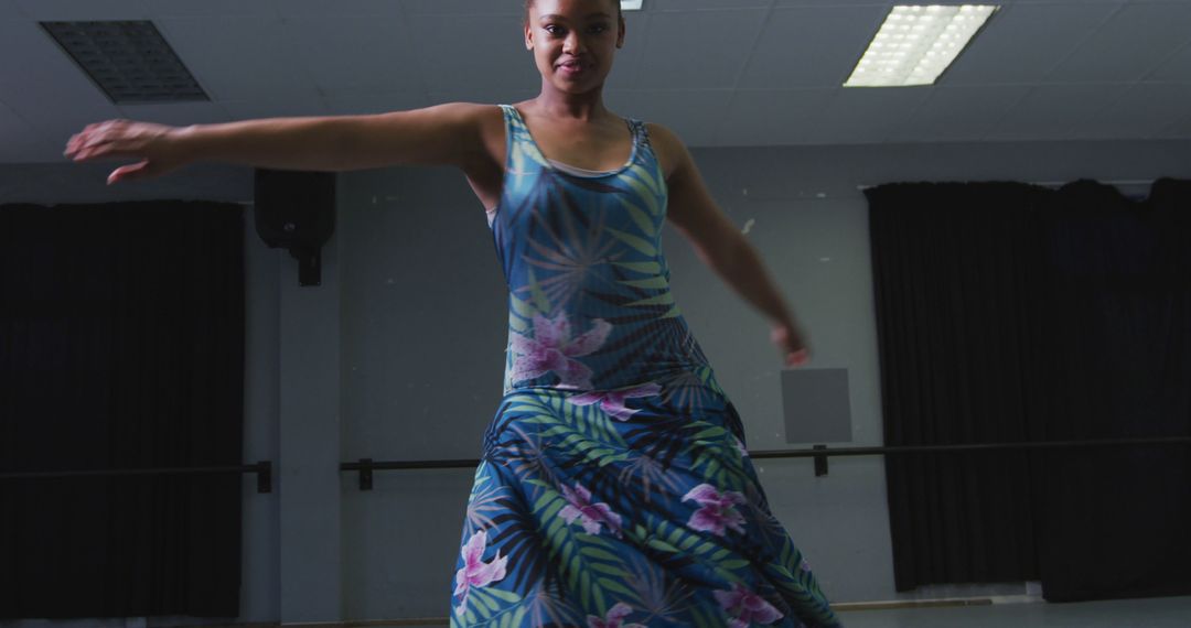 Confident Dancer Twirling in Floral Dress During Rehearsal - Free Images, Stock Photos and Pictures on Pikwizard.com