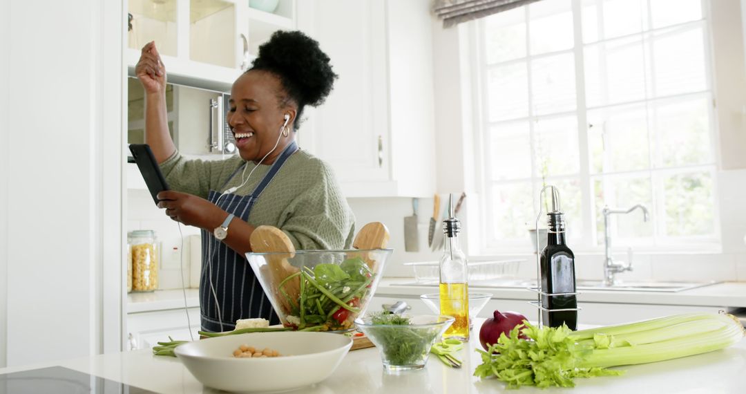 Joyful Woman Cooking Healthy Meal in Modern Kitchen - Free Images, Stock Photos and Pictures on Pikwizard.com