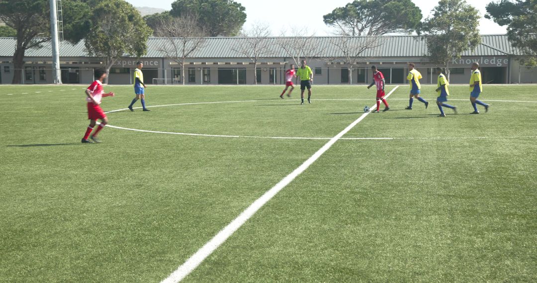 Soccer Players Strategizing on Field Before Match