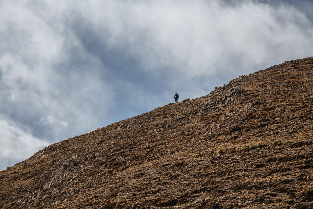 Solo Hiker on Mountain Ridge with Dramatic Sky - Free Images, Stock Photos and Pictures on Pikwizard.com