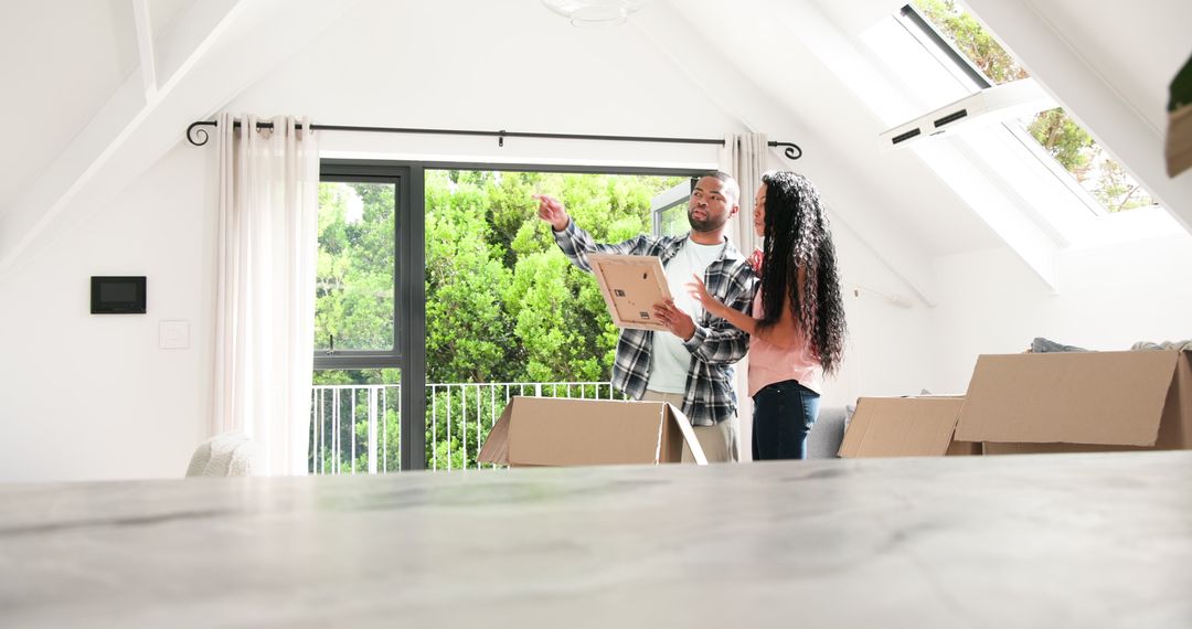 Couple Unpacking in Sunlit Room, Embracing New Home Adventure