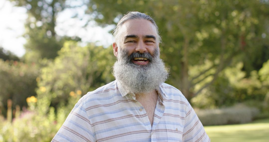 Smiling Bearded Man Enjoying Nature in Park