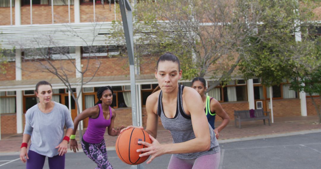 Diverse female basketball team playing match, dribbling ball - Free Images, Stock Photos and Pictures on Pikwizard.com