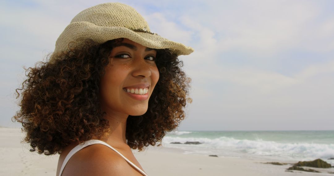 Smiling Woman in Sun Hat Enjoying Beach Day