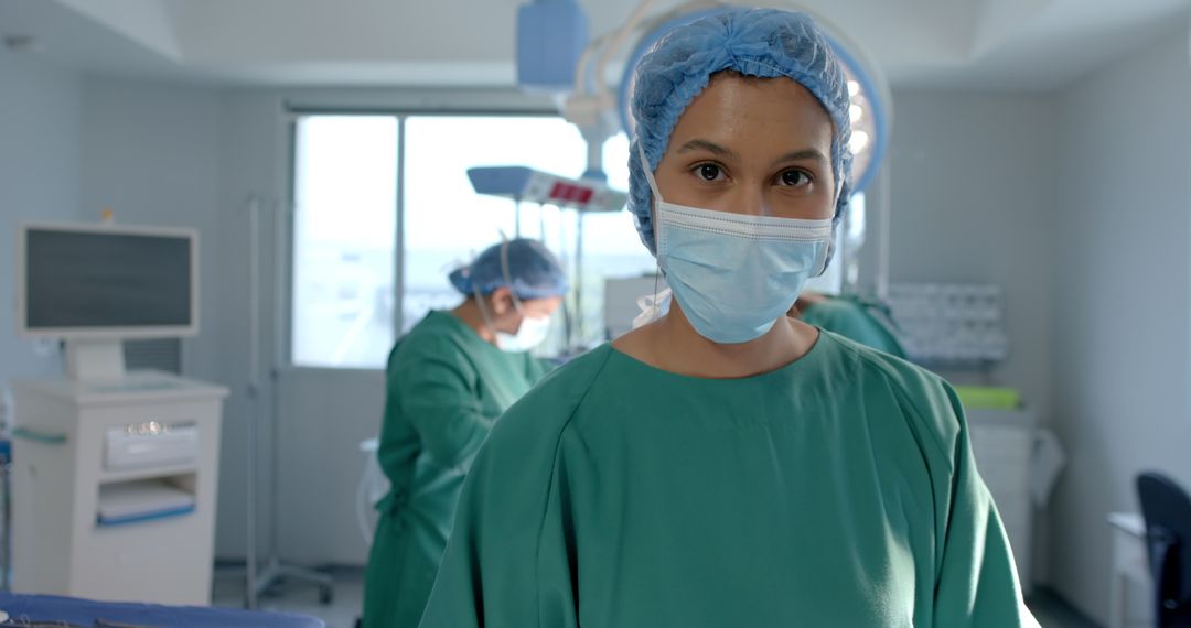 Focused Female Surgeon in Operating Room with Teamwork in Background