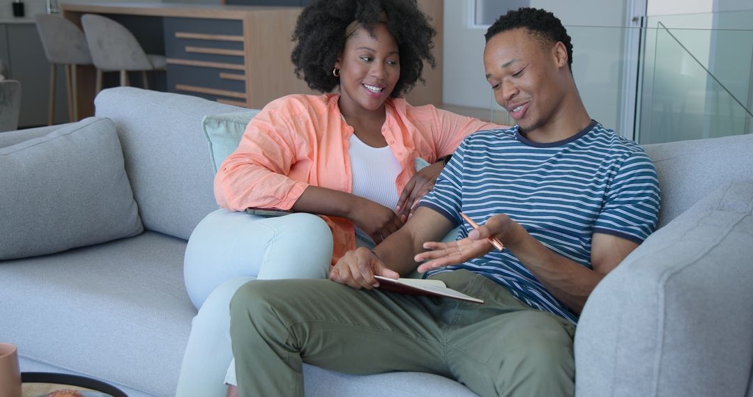 Young Couple Relaxing at Home with Tablet and Book
