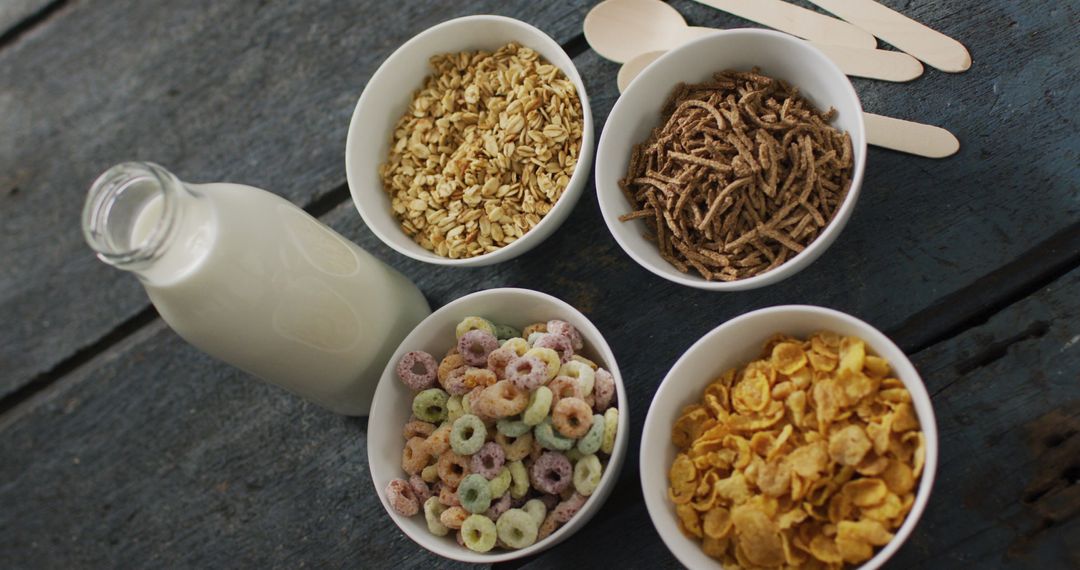 Assorted Cereals with Milk for Healthy Breakfast on Rustic Surface