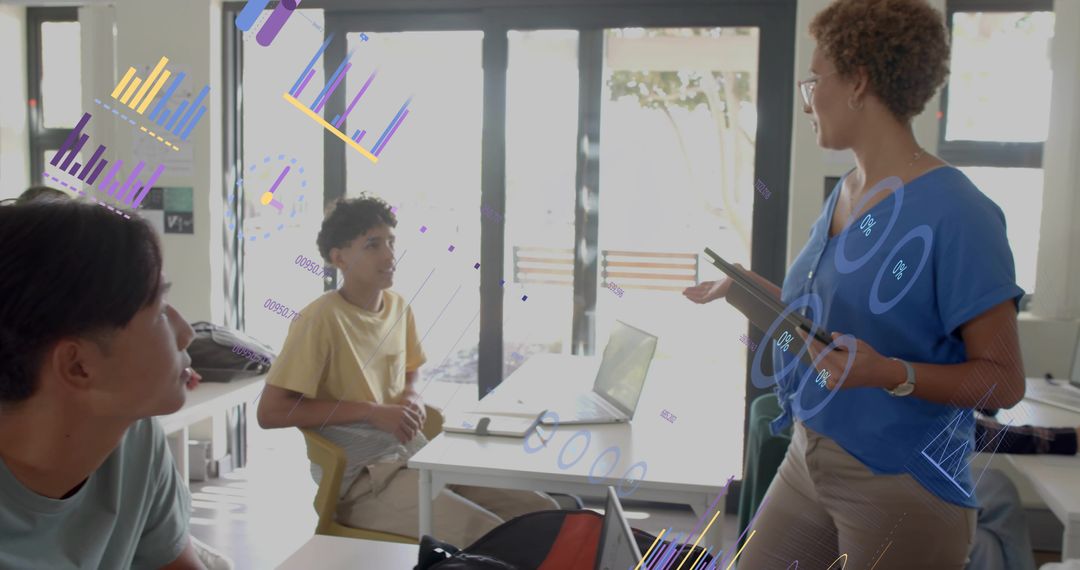 Teacher presenting interactive data overlays to students using laptops and tablets in classroom