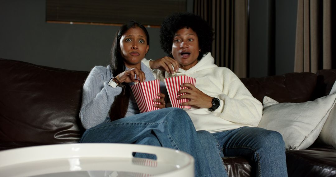 Excited Couple Watching Movie, Grabbing Popcorn Together