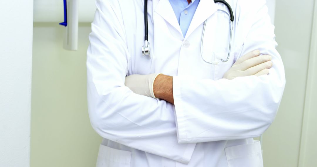 Midsection of Doctor with Stethoscope and Crossed Arms in Clinic - Free Images, Stock Photos and Pictures on Pikwizard.com