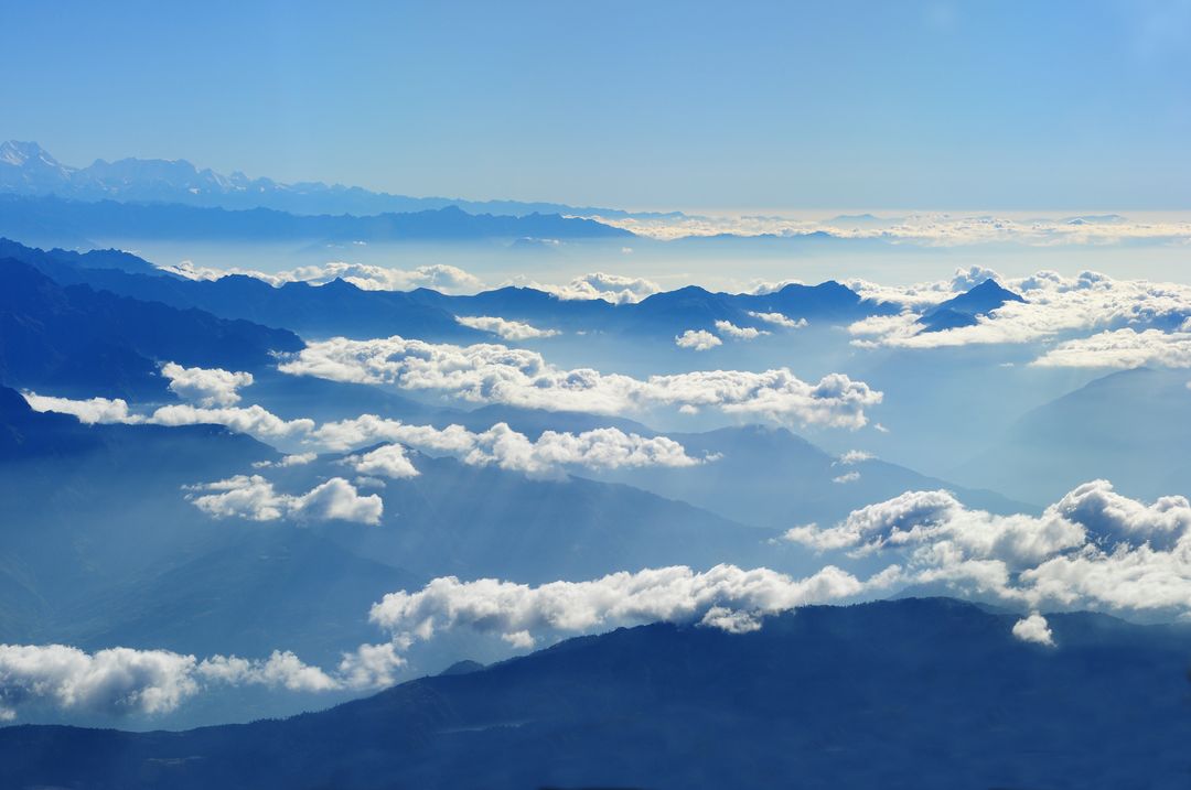 Scenic View of Clouds over Mountains Against Blue Sky - Free Images, Stock Photos and Pictures on Pikwizard.com