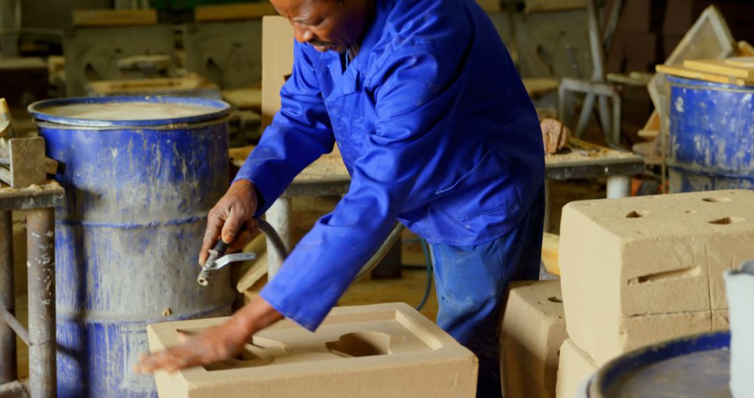 Skilled Worker Shaping Clay Material in Workshop - Free Images, Stock Photos and Pictures on Pikwizard.com