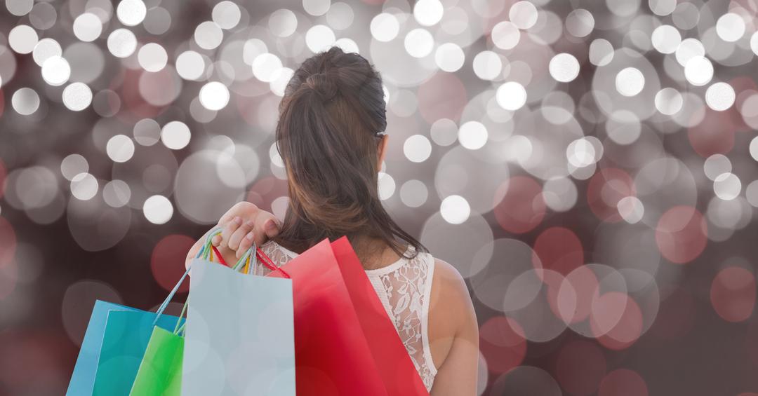 Woman Holding Shopping Bags with Festive Bokeh Background - Free Images, Stock Photos and Pictures on Pikwizard.com