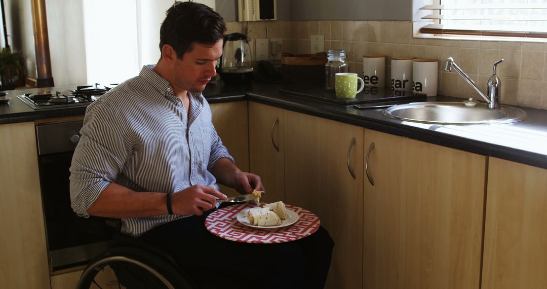 Man in wheelchair preparing food independently in home kitchen - Free Images, Stock Photos and Pictures on Pikwizard.com