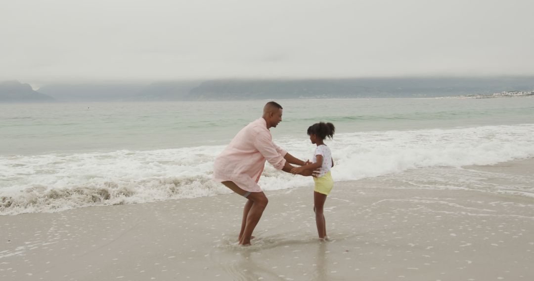 Father and Daughter Playing on the Beach at Sunset - Free Images, Stock Photos and Pictures on Pikwizard.com