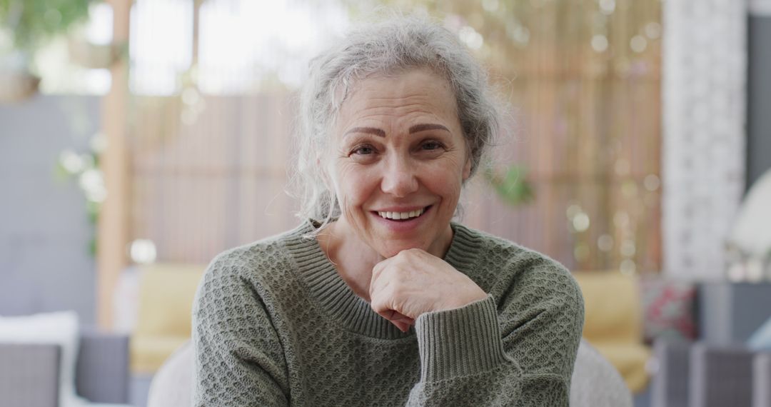 Senior Woman Smiling in Relaxing Indoor Environment - Free Images, Stock Photos and Pictures on Pikwizard.com